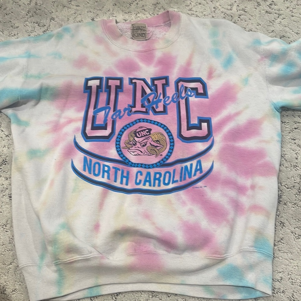 First of A kind UNC sweatshirt fits like a small/medium